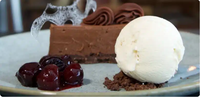 Baked Chocolate Cheesecake with a scoop of ice cream