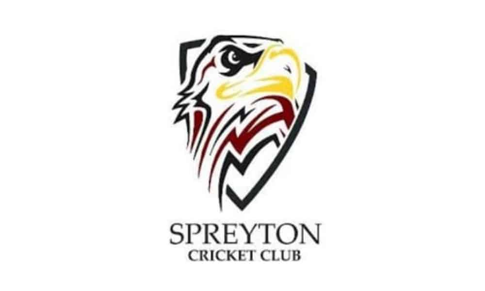 Stylised eagle head inside a shield; "Spreyton Cricket Club" written below.
