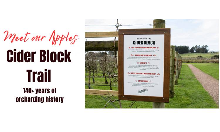 A sign at the entrance to an orchard titled “Cider Block Trail” includes information about the orchard’s 140+ year history and directions for visitors.